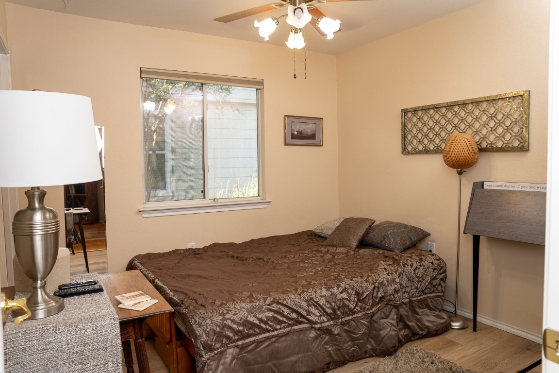 1612 Poppy Seed Lane Austin, TX 78741 - Photo 10 of 18 a bedroom with a bed and wooden floor