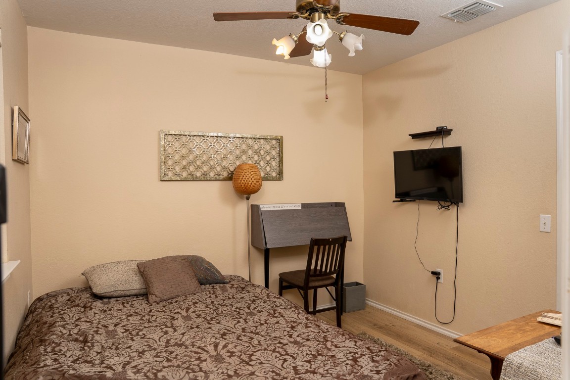 1612 Poppy Seed Lane Austin, TX 78741 - Photo 11 of 18 a bedroom with a bed and a flat screen tv