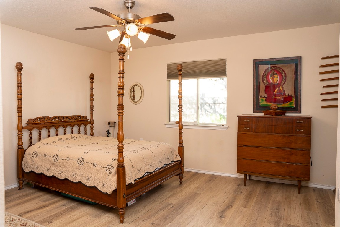 1612 Poppy Seed Lane Austin, TX 78741 - Photo 6 of 18 a bedroom with a bed and a dresser