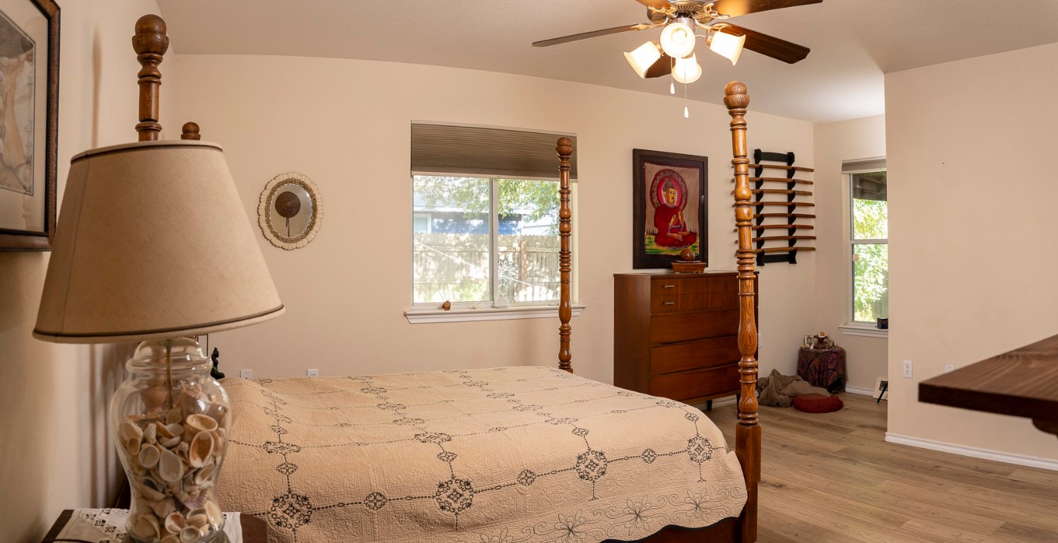 1612 Poppy Seed Lane Austin, TX 78741 - Photo 7 of 18 a bedroom with a bed and a chandelier