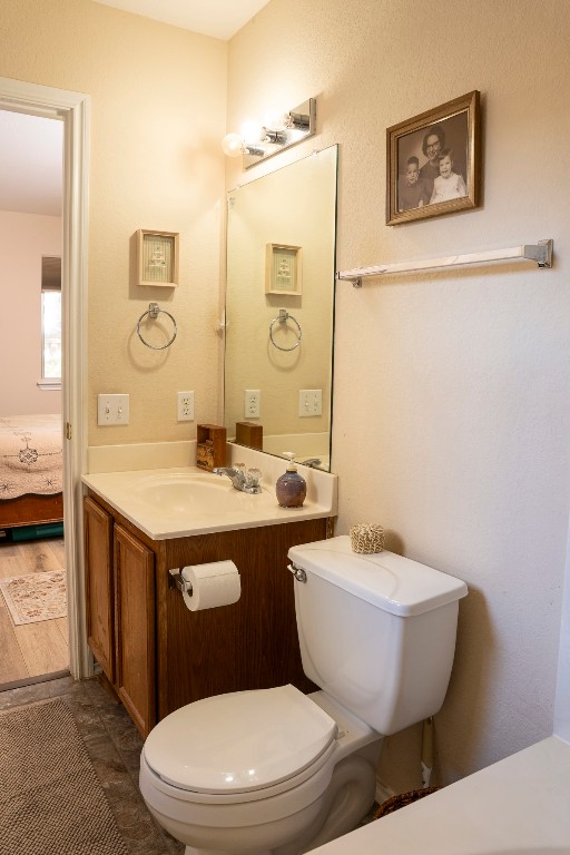 1612 Poppy Seed Lane Austin, TX 78741 - Photo 9 of 18 a bathroom with a granite countertop toilet sink and mirror