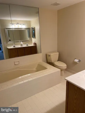 a bathroom with a sink a toilet and mirror