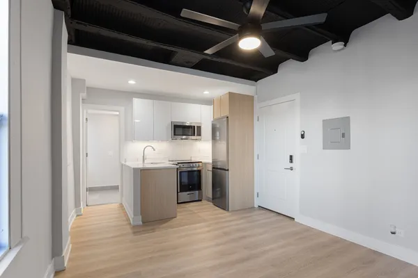 a large kitchen with a stove and a refrigerator
