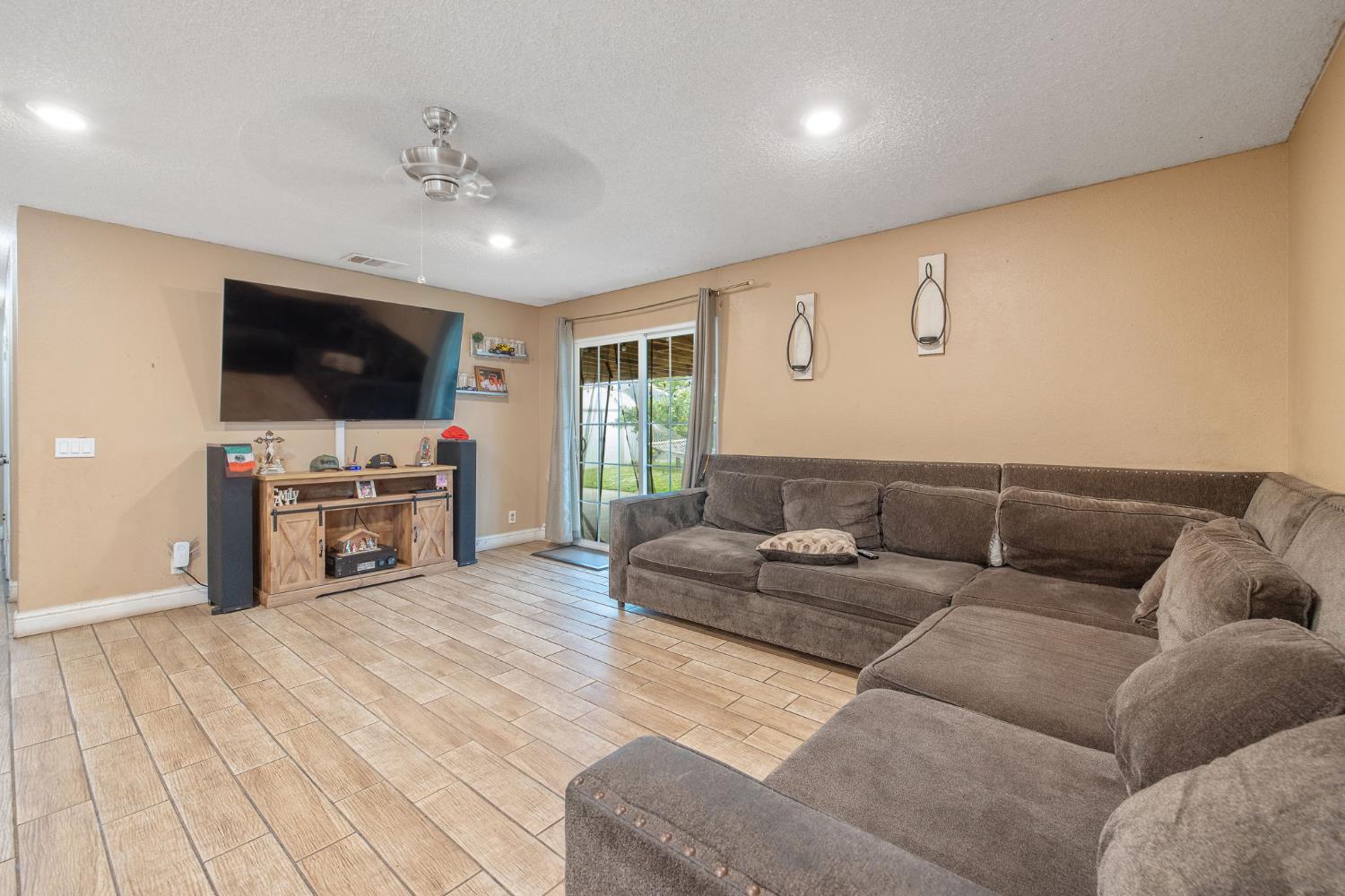 105 West Clark Street Madera, CA 93638 - Photo 16 of 33 a living room with furniture and a flat screen tv