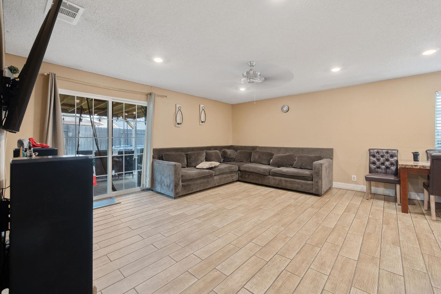 105 West Clark Street Madera, CA 93638 - Photo 17 of 33 a living room with furniture and a flat screen tv