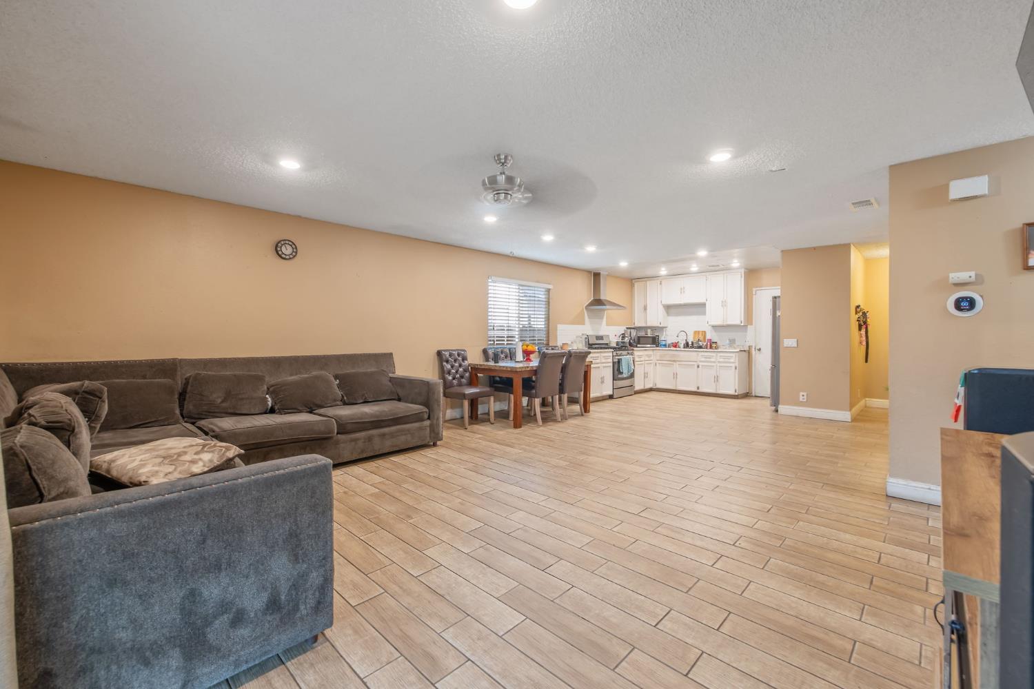 105 West Clark Street Madera, CA 93638 - Photo 18 of 33 a living room with furniture and kitchen view