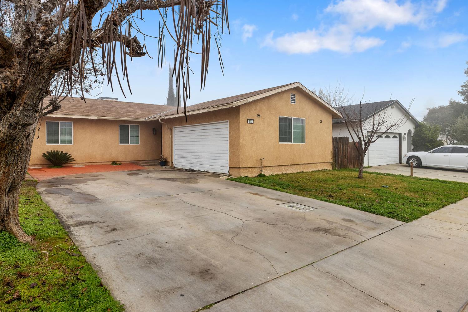 105 West Clark Street Madera, CA 93638 - Photo 2 of 33 a front view of a house with yard