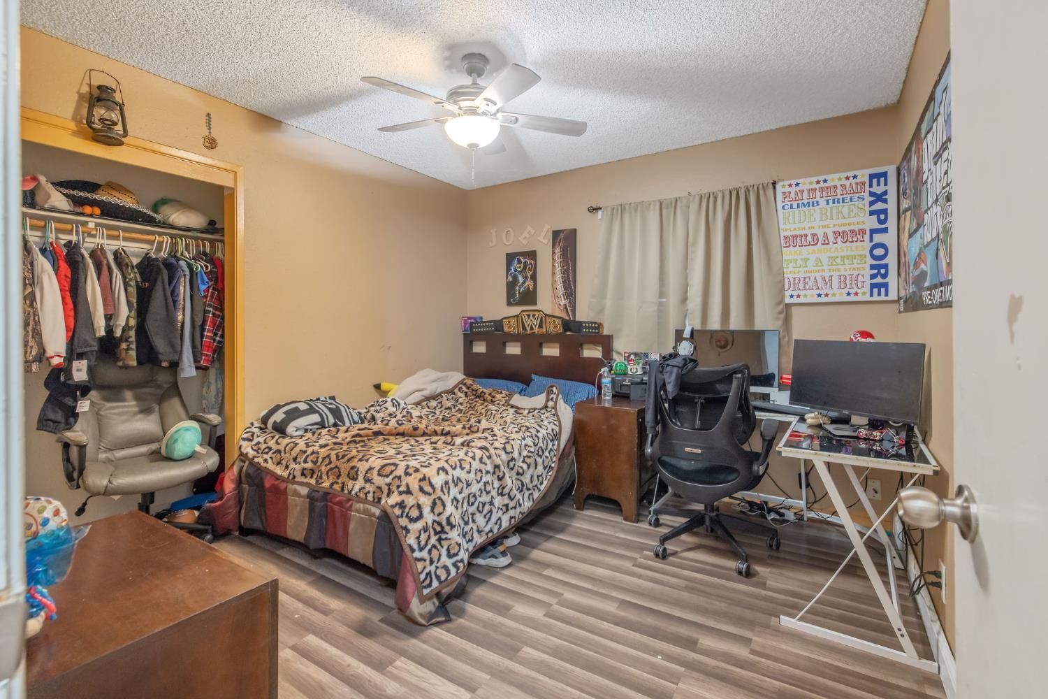 105 West Clark Street Madera, CA 93638 - Photo 23 of 33 a bedroom with a bed and a chandelier
