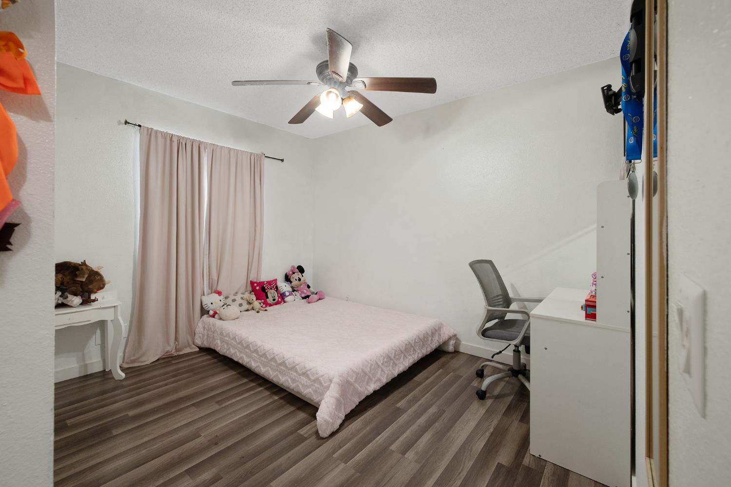 105 West Clark Street Madera, CA 93638 - Photo 24 of 33 a bedroom with a bed and a chandelier