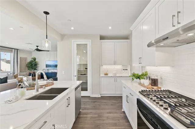 a kitchen with a sink stove and cabinets