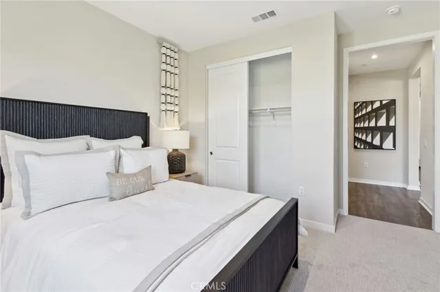 a bedroom with a bed and a painting