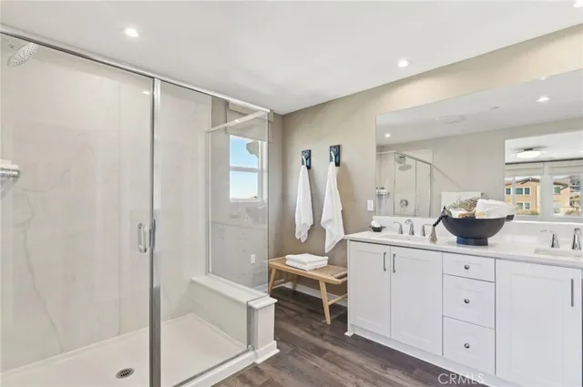 a bathroom with a double vanity sink toilet and shower