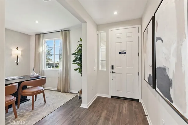 a view of a hallway with wooden floor and furniture