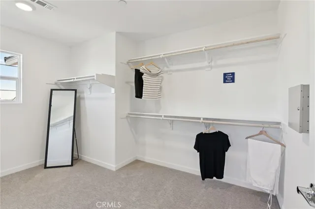 a view of storage and utility room with refrigerator and sink