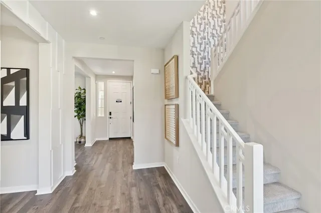 a view of a hallway with wooden floor and entryway