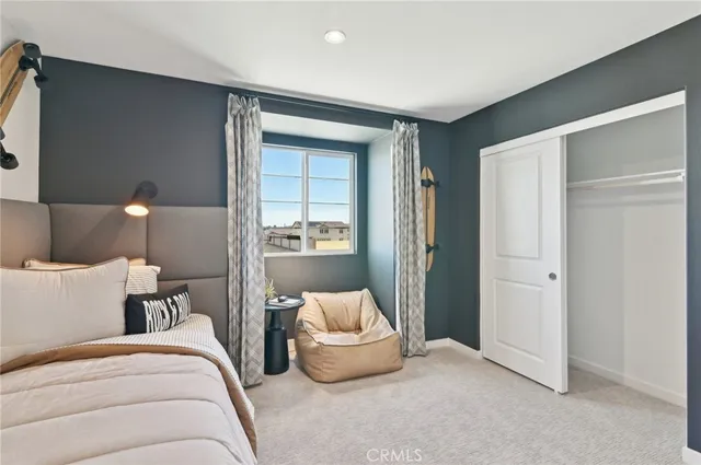 a bedroom with a bed and a couch