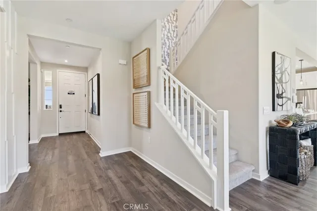a view of an entryway with wooden floor