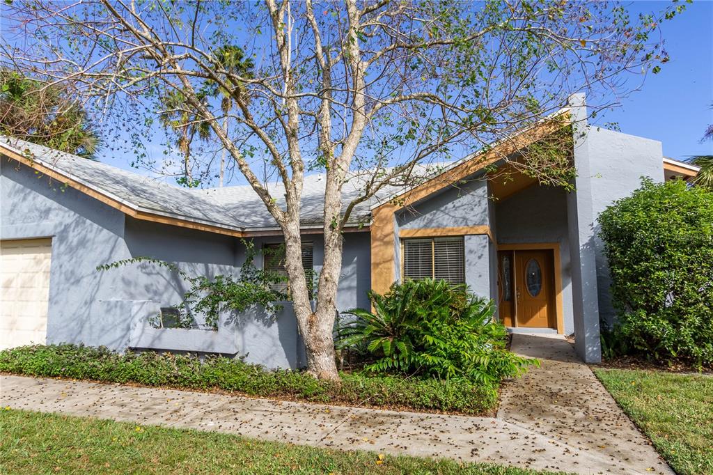405 Willowbrook Lane Longwood, FL 32779 - Photo 1 of 11 a front view of a house with garden