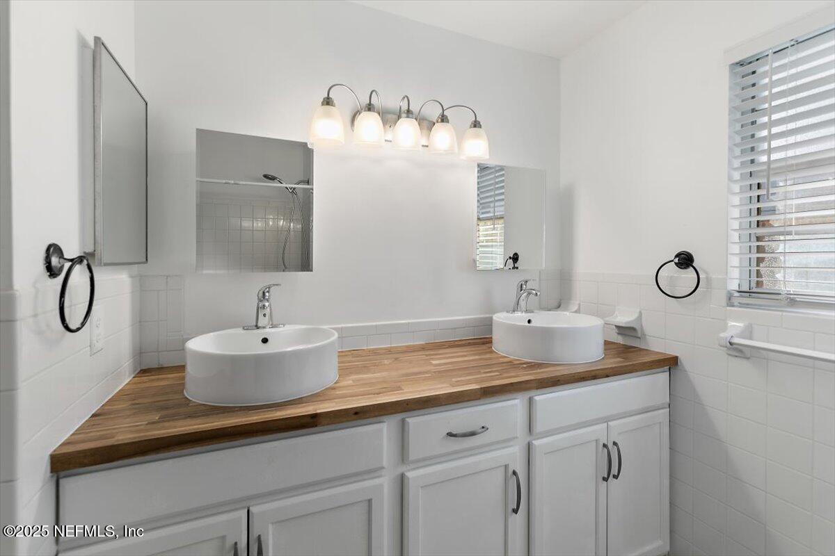 8408 Brierwood Road Jacksonville, FL 32217 - Photo 15 of 25 a bathroom with a sink and mirror