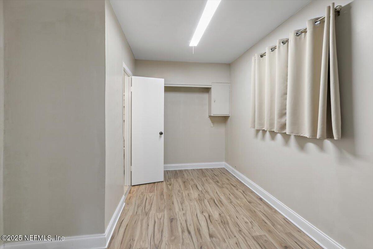 8408 Brierwood Road Jacksonville, FL 32217 - Photo 23 of 25 a view of a room with wooden floor and bench