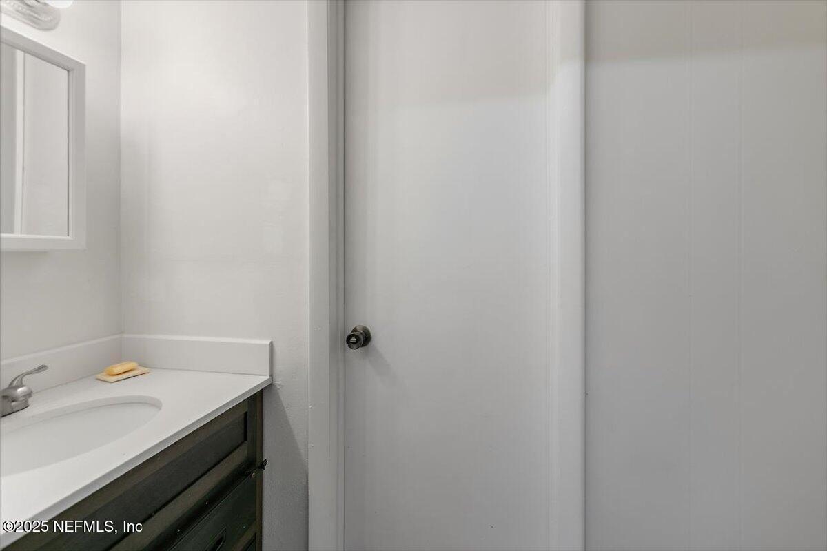 8408 Brierwood Road Jacksonville, FL 32217 - Photo 24 of 25 a bathroom with a sink and vanity