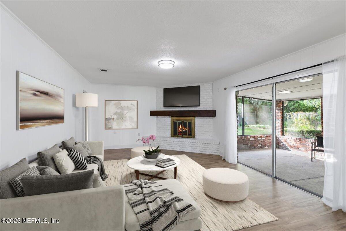 8408 Brierwood Road Jacksonville, FL 32217 - Photo 6 of 25 a living room with furniture and a flat screen tv