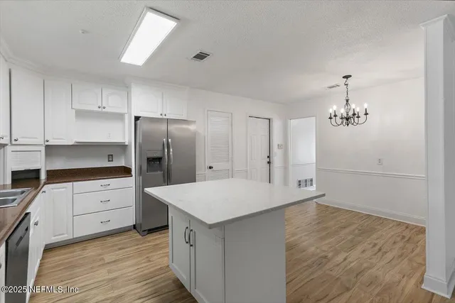 a kitchen with a refrigerator a sink and dishwasher