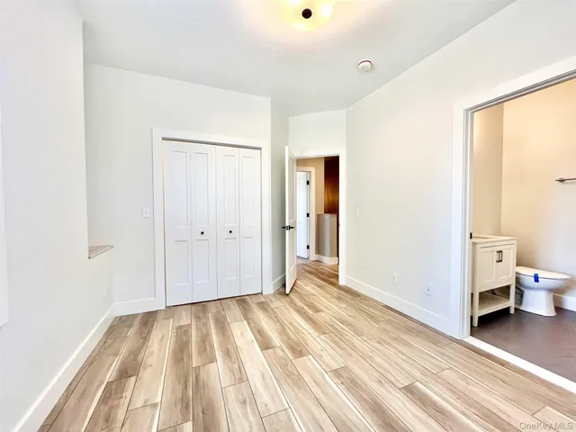 a view of a room with wooden floor and a sink