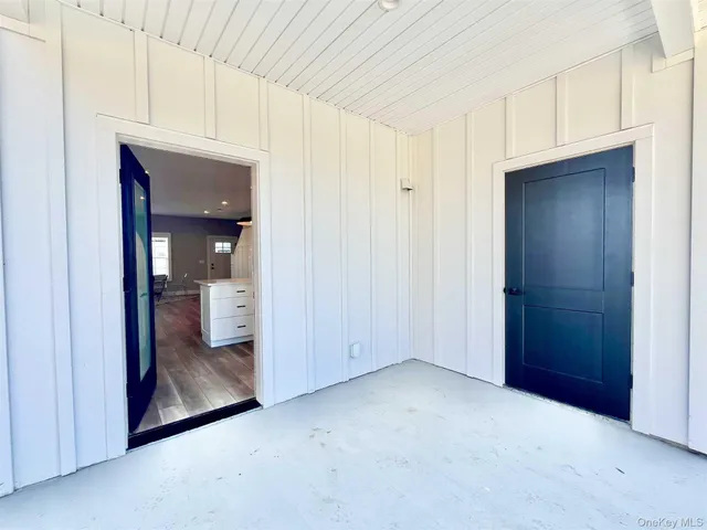 a view of an empty room and a bathroom
