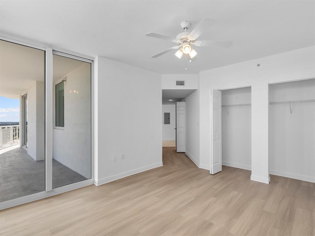 1745 East Hallandale Beach Boulevard, Unit 2007W Hallandale Beach, FL 33009 - Photo 8 of 16 a view of an empty room with wooden floor and a large mirror