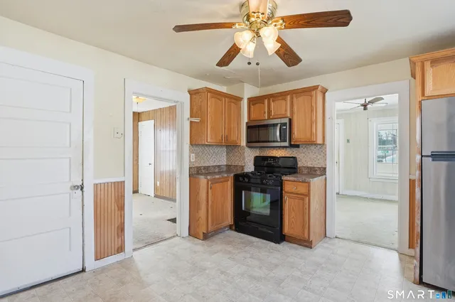 a kitchen with stainless steel appliances granite countertop a refrigerator and a stove top oven