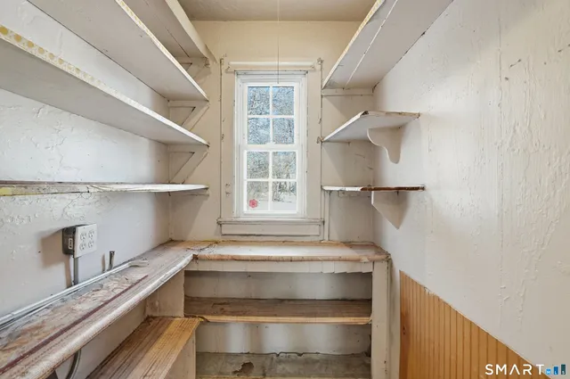 a view of walk in closet with empty racks