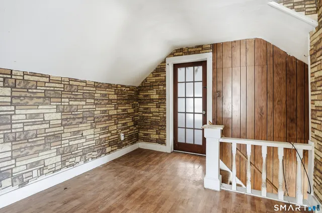 a view of a windows and an entryway with wooden floor