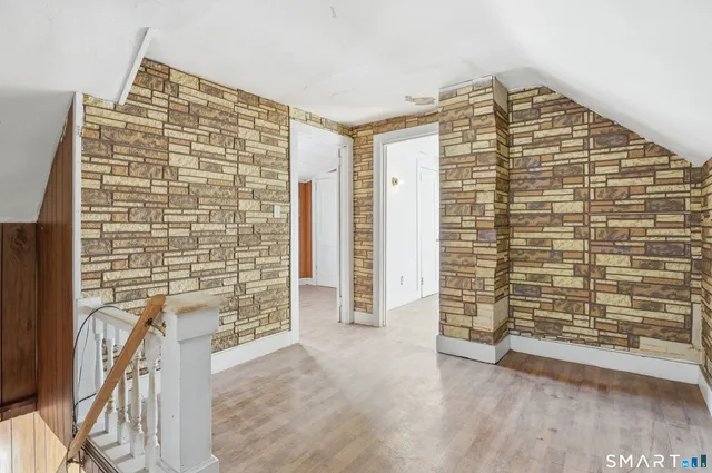 a view of empty room with cabinet and windows