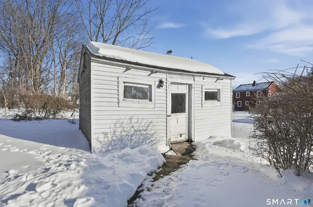 a view of a house with a snow in the yard