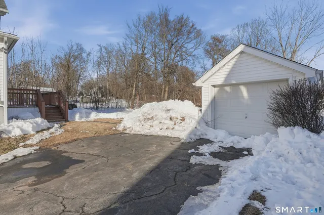 a view of a house with a yard covered in snow