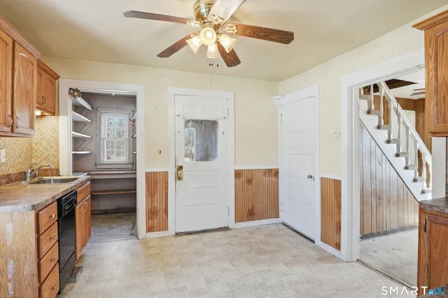 a view of a kitchen with furniture and a ceiling fan