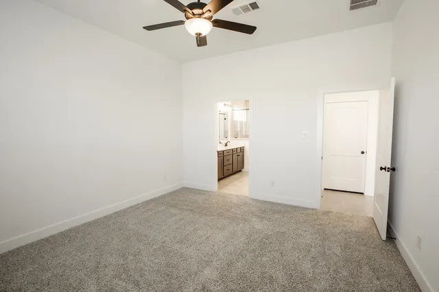 an empty room with closet and windows