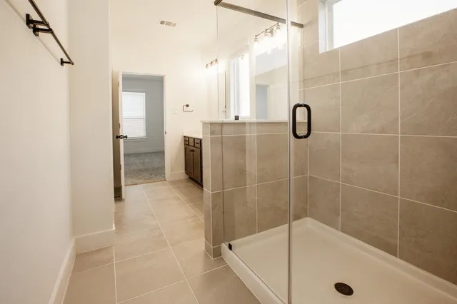 a bathroom with a tub and shower