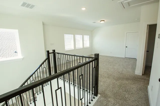 a view of a hallway view with staircase
