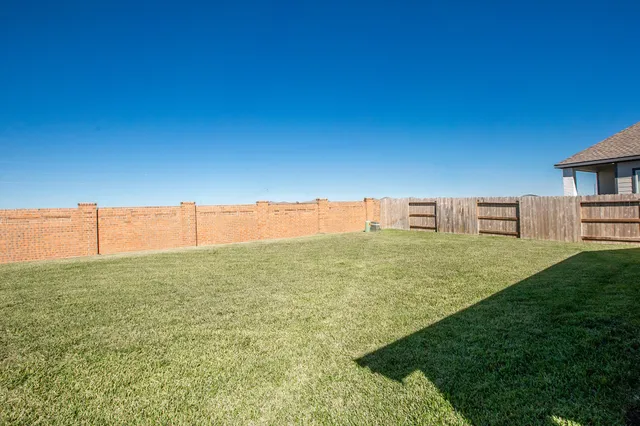 a view of a big house with a big yard