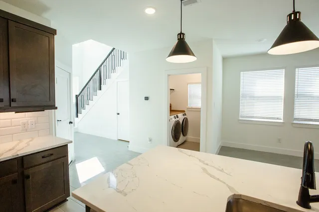 a bedroom with a bed and a view of living room