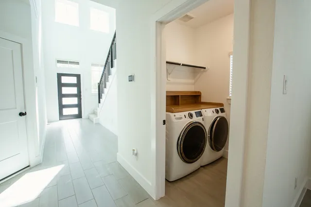 a view of a hallway with washer and dryer