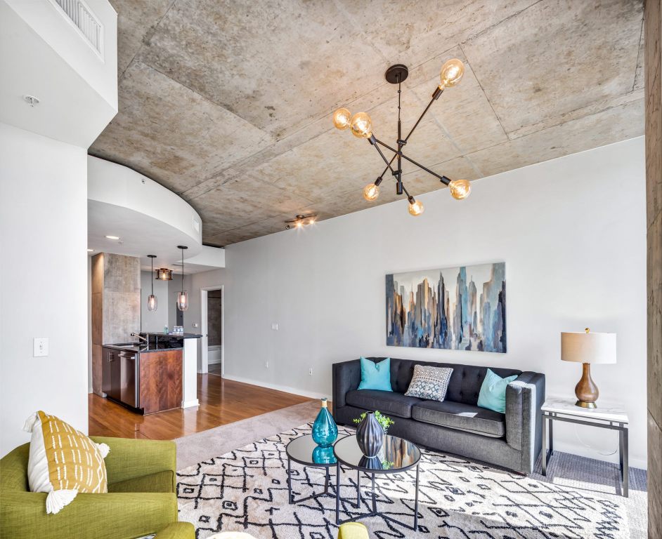 a living room with furniture and kitchen view