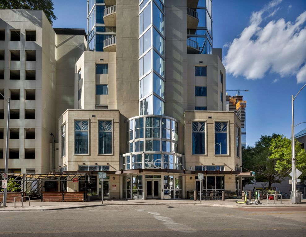 360 Nueces Street, Unit 2906 Austin, TX 78701 - Photo 9 of 9 a city street lined with tall buildings and a street light pole