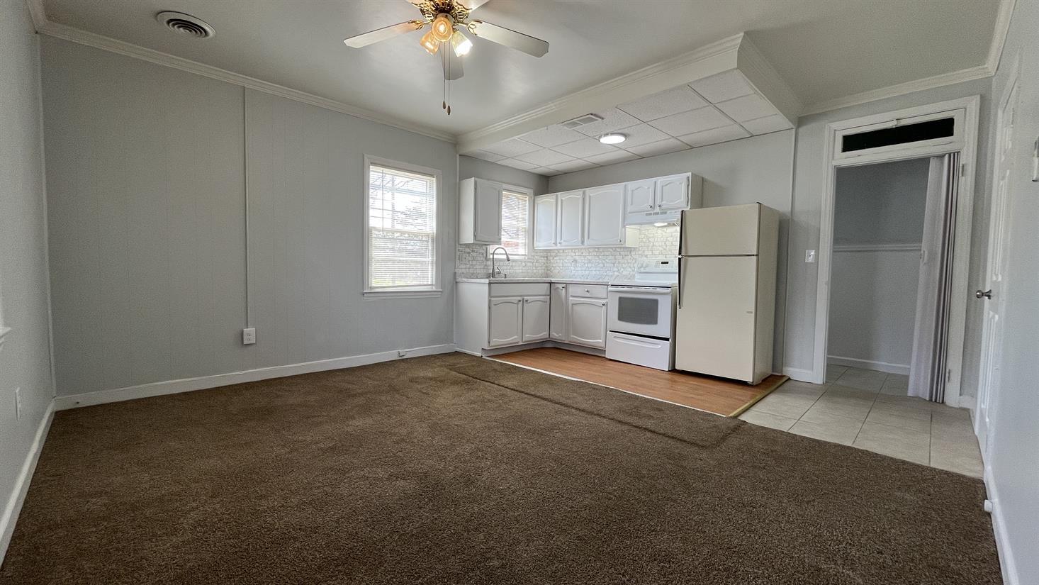 704 Blue Ridge Avenue, Unit 5 Bedford, VA 24523 - Photo 4 of 10 an empty room with windows and ceiling fan