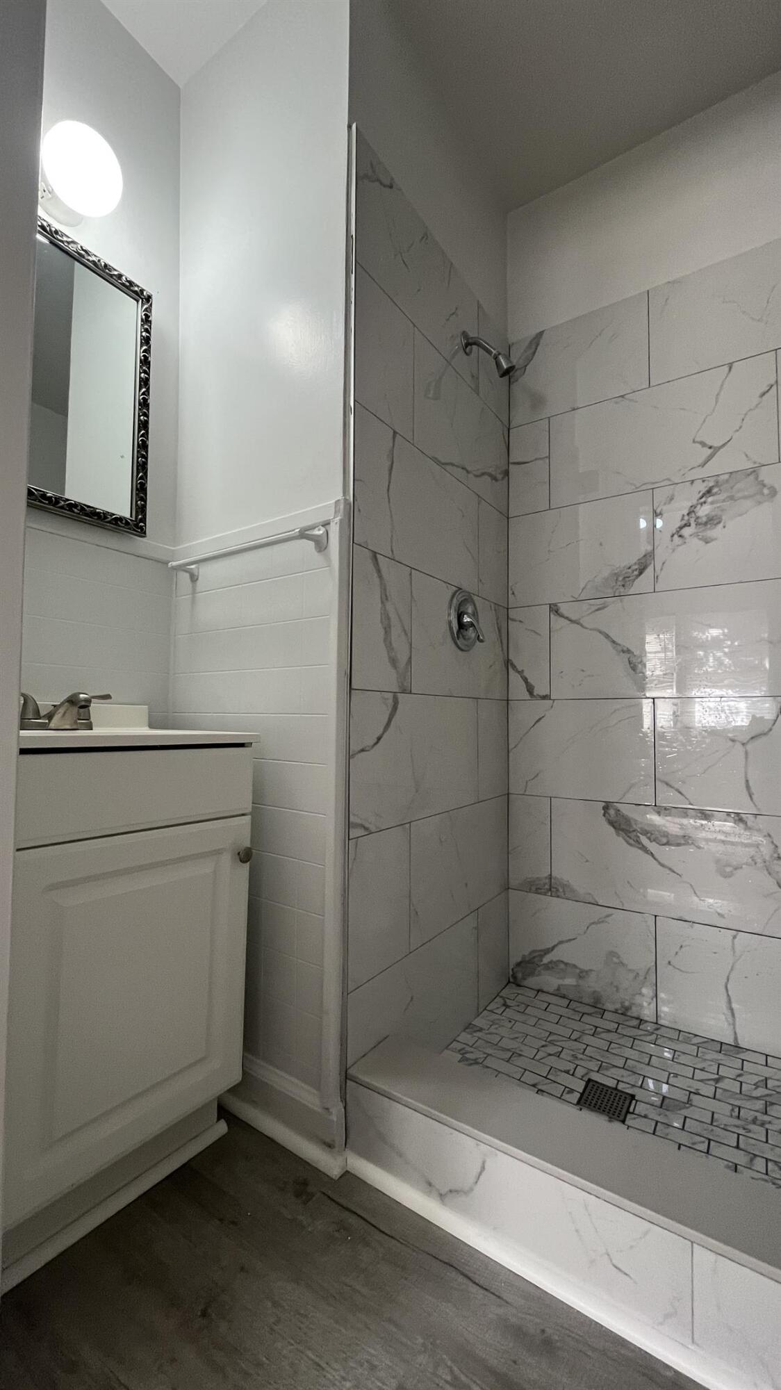 704 Blue Ridge Avenue, Unit 5 Bedford, VA 24523 - Photo 6 of 10 a bathroom with a sink a toilet and shower