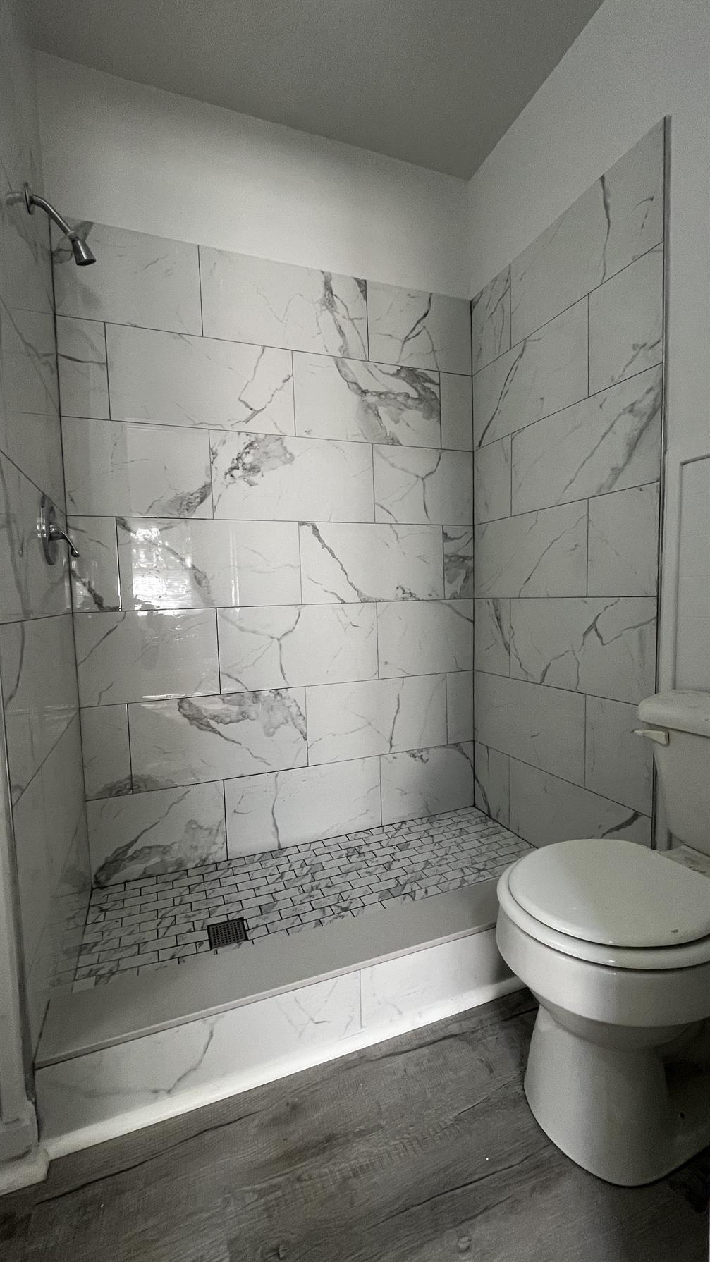 704 Blue Ridge Avenue, Unit 5 Bedford, VA 24523 - Photo 7 of 10 a bathroom with a toilet and a shower