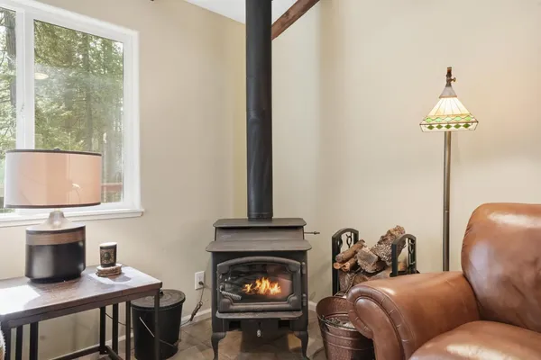 a kitchen with stainless steel appliances granite countertop a stove a sink dishwasher and a dining table with wooden floor