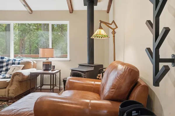 a kitchen with stainless steel appliances granite countertop a stove a sink and a dining table with wooden floor